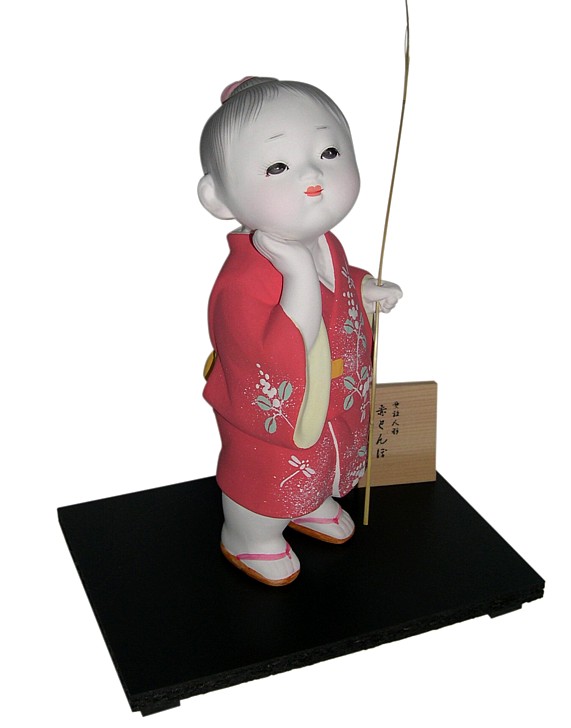 Japanese Hakata doll of a Boy in red kimono and with twig