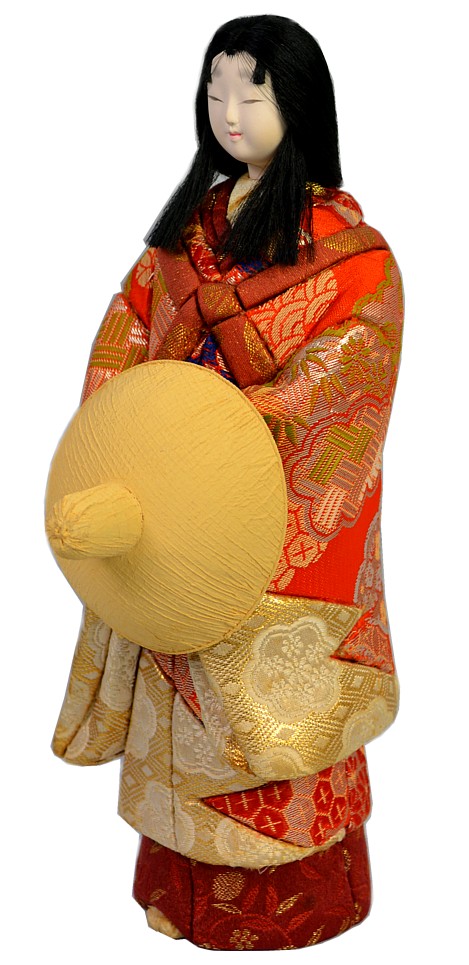 japanese kimekomi doll  with straw hat in her hands