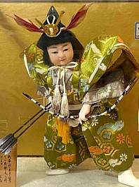 japanese antique doll of a young samurai with big bow and arrows