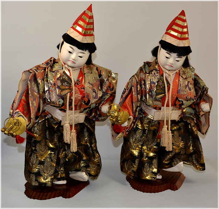 Japanese antique dolls of twin boys dancing with bells in their hands, Meiji period