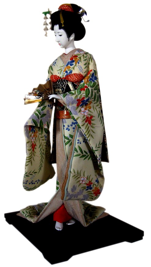 japanese doll in ivory-colored silk kimono and silk-brocaded black obi belt