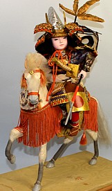japanese antique doll of a young samurai on a battle horse