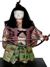 japanese doll of young samurai with sword tachi in his hand