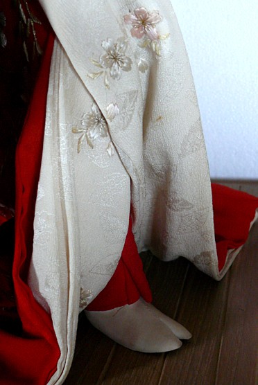 detail of embroidery on a doll's kimono