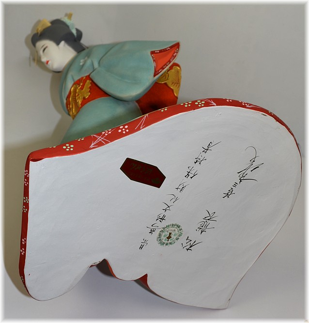 japanese hakata clay doll of a geisha with folding fan, artist signature