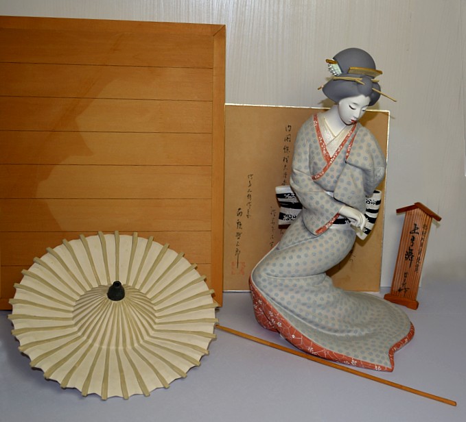 Japanese clay doll of a dancing geisha. Composition