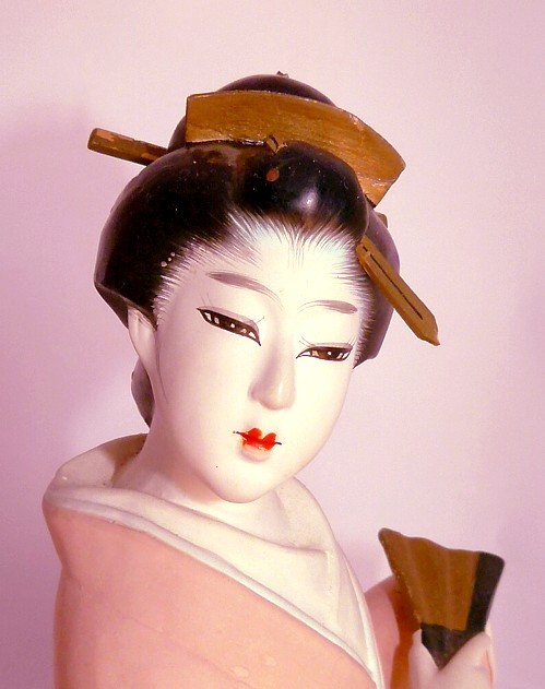 japanese antique hakata doll of a woman with folding fan