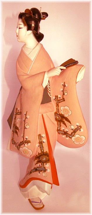 japanese antique hakata doll of a woman in light pink kimono with cherry blossom motif