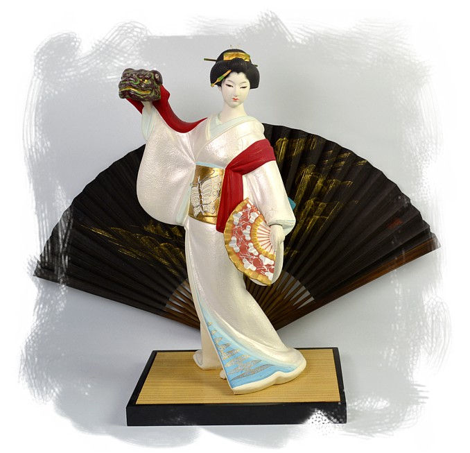japanese traditional ceramic doll of a geisha dancing with lion mask